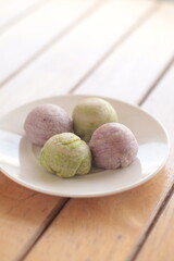 Cute Chinese Pastry or moon cake stuffed with salted egg yolk on wood plate