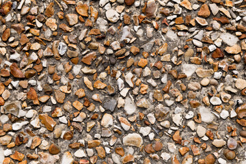 Rough crushed stone wall texture background.