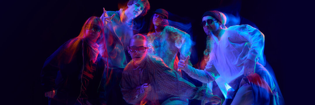 Street dancers posing under vivid motion blur lights. Concept of hip hop culture, artistic expression, performing arts visuals, and lifestyle branding promotion. Banner