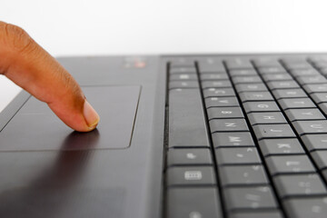 a finger using the touchpad on a laptop