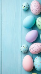 Pastel easter eggs border on blue wooden background