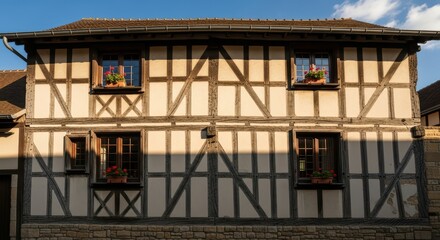 Charming half-timbered house with flowers and wooden windows