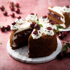 Chocolate cake with whipped cream and cherries