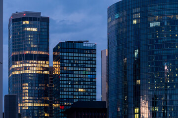 Frankfurt skyline with modern architecture and glass business tower under blue hour urban atmosphere reflecting city lights across finance district