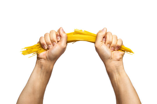 Two hands breaking spaghetti pasta in half isolated from background