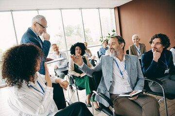 Professionals engaged in a dynamic business conference discussing growth strategies in a modern...