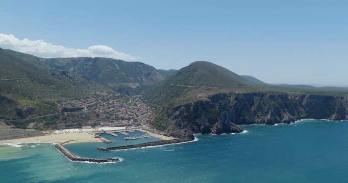 Aerial view of Buggerru, Sardinia, showing rugged coast and blue sea