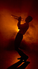 Trumpet player leaning back while performing under orange light. Concept of fashion brand styling with music mood, SMM for musicians and clubs, and editorial features. © Lustre Art Group 