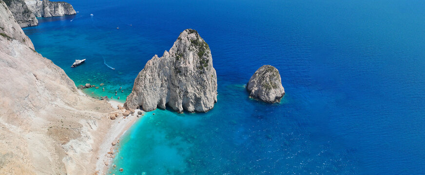 Aerial drone ultra wide panoramic photo of scenic small islet of Mizithres in Keri area forming double turquoise sandy beaches a true paradise for small boats, Zakinthos island, Ionian, Greece