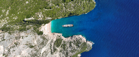 Aerial drone ultra wide panoramic top down photo with copy space of luxury yacht anchored in tropical exotic island with crystal clear turquoise sea © aerial-drone