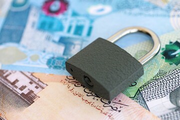 Bahraini dinar currency money bills and padlock close up. The concept of sanctions and financial...