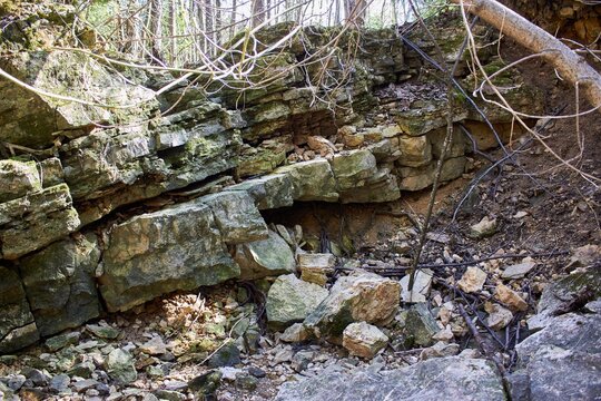 Raw limestone strata reveal Earth's ancient story. Jagged, moss-kissed layers evoke resilience, a silent testament to time's slow grind. A rugged geological narrative unfolds