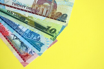 Bahraini dinar money bills in big amount on yellow close up. Finance and banking concept