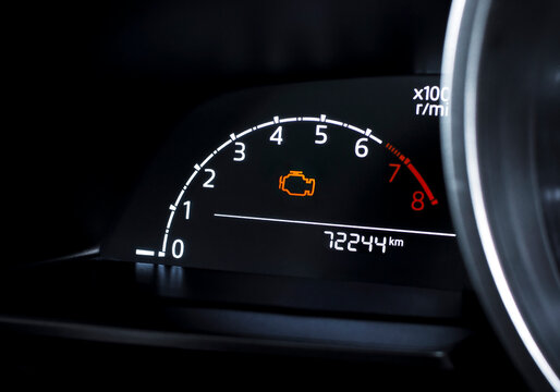 Check engine warning light on car dashboard, close-up of illuminated malfunction indicator symbol, vehicle diagnostics, car maintenance and engine problem alert concept
