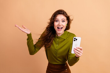 Young woman joyful selfie promotion casual fashion style against beige backdrop