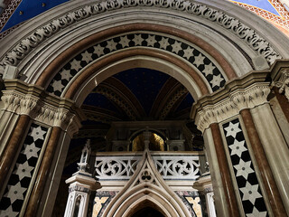 Fototapeta premium Intricate arches and star mosaic adorn a sacred archway in Assisi Italy church interior