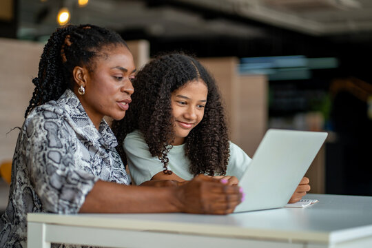African school teacher is teaching and guiding young student in the class using information from experience and internet for academic literacy study and education