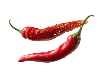 Two vibrant red chilies, one dusted with spices, against black