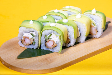 High-quality close-up of fresh salmon and tuna sushi rolls served on a black ceramic plate. Ideal for Japanese restaurant menu design.