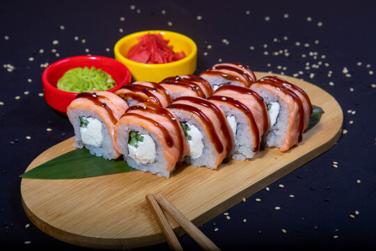Delicious Japanese sushi set with nigiri, maki rolls, and soy sauce served on a wooden board. Traditional Asian cuisine concept.