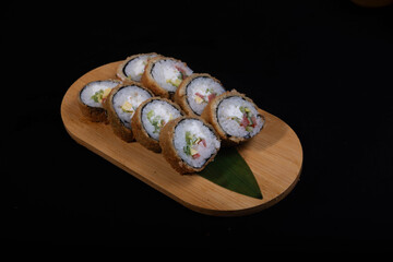 Delicious Japanese sushi set with nigiri, maki rolls, and soy sauce served on a wooden board. Traditional Asian cuisine concept.