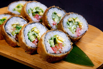 Delicious Japanese sushi set with nigiri, maki rolls, and soy sauce served on a wooden board. Traditional Asian cuisine concept.