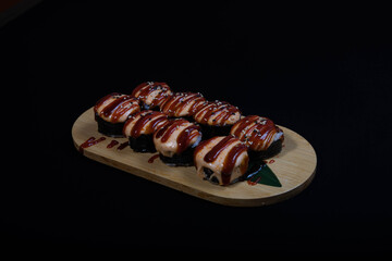 Delicious Japanese sushi set with nigiri, maki rolls, and soy sauce served on a wooden board. Traditional Asian cuisine concept.