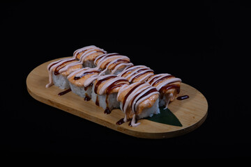 Delicious Japanese sushi set with nigiri, maki rolls, and soy sauce served on a wooden board. Traditional Asian cuisine concept.