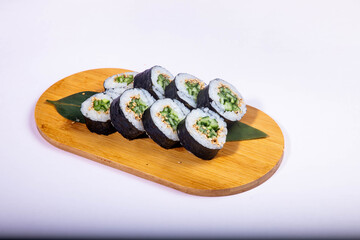 Delicious Japanese sushi set with nigiri, maki rolls, and soy sauce served on a wooden board. Traditional Asian cuisine concept.