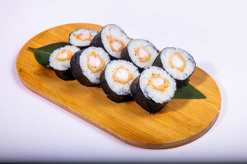 Delicious Japanese sushi set with nigiri, maki rolls, and soy sauce served on a wooden board. Traditional Asian cuisine concept. © Ulgen