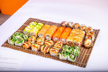 Delicious Japanese sushi set with nigiri, maki rolls, and soy sauce served on a wooden board. Traditional Asian cuisine concept. © Ulgen