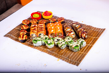 Delicious Japanese sushi set with nigiri, maki rolls, and soy sauce served on a wooden board. Traditional Asian cuisine concept. © Ulgen