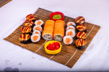 Delicious Japanese sushi set with nigiri, maki rolls, and soy sauce served on a wooden board. Traditional Asian cuisine concept. © Ulgen