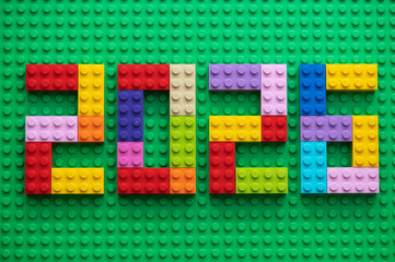 Naklejka premium The numbers 2026 are laid out from multi-colored Lego bricks.