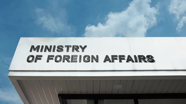 A ministry of foreign affairs word sign displayed on a governmental building under a clear blue sky, symbolizing diplomacy, international relations, and global policy