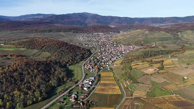 Aerial view of the charming Rouffach cityscape nestled between rolling hills and vibrant vineyards, a picturesque scene of rural beauty, Rouffach, Grand Est, France.