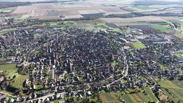 Aerial view of Rouffach showing the town's intricate layout nestled among fields and vineyards, offering a glimpse into its historical charm, Rouffach, Grand Est, France.