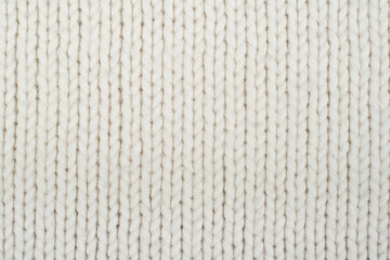 Sweater or scarf fabric texture large knitting. Knitted jersey background with a relief pattern. Wool hand- machine, handmade.