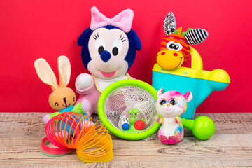 Collection of colorful toys on red background.