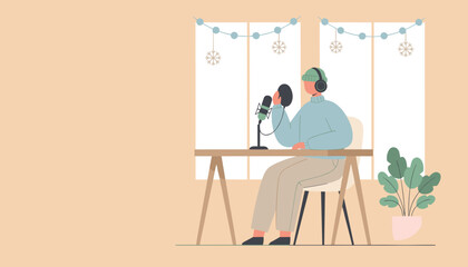 Podcaster recording audio content at home wearing headphones in a cozy decorated winter setting