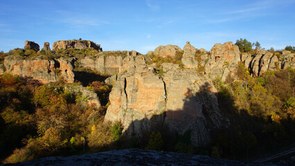 Belogradchik Rocks in the rays of the rising sun. Autumn. Bulgaria.