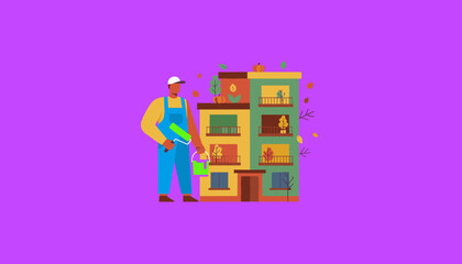 Maintenance worker painting a colorful apartment building during autumn renovation