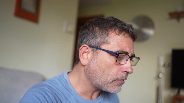 A contemplative man wearing glasses is deeply immersed in thought and reflection