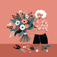 A person with white hair holds a floral bouquet, scissors, and flower parts sit on a table