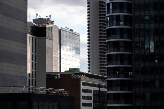 Modern architecture skyline of office towers with glass reflection and geometric facade in La Defense district of Paris France under bright daylight urban city atmosphere