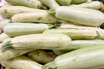 Zucchini in basket at grocery store, fruits and vegetables are sold at market