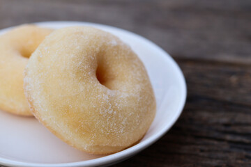 Sugar donuts on white plate