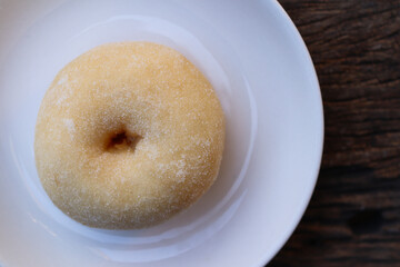 Sugar donuts on white plate