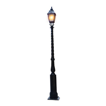 A classic cast iron street lamp with an ornate, twisted pole design, illuminated with a warm glow, isolated on a white background for easy editing