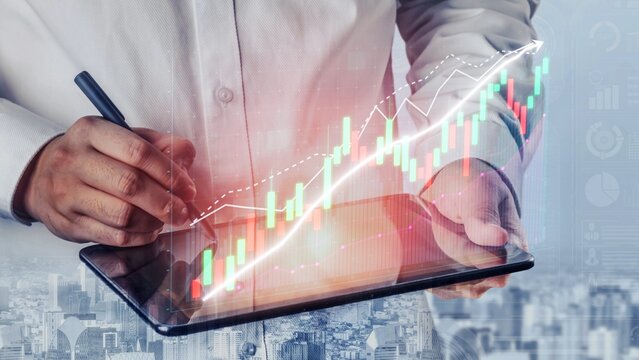 A business professional uses a digital tablet to analyze financial data with a dynamic graph overlay, representing market trends and growth strategies for success. Copula - Powered by Adobe
